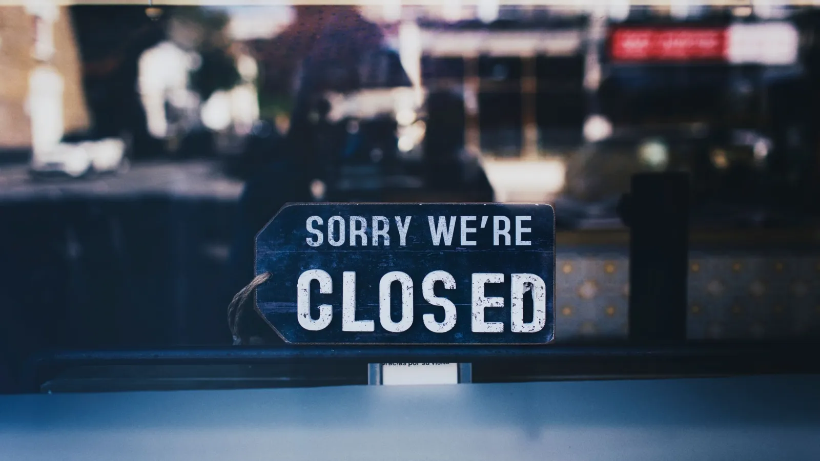 A sign reading Sorry we're closed hanging in a London shop window.